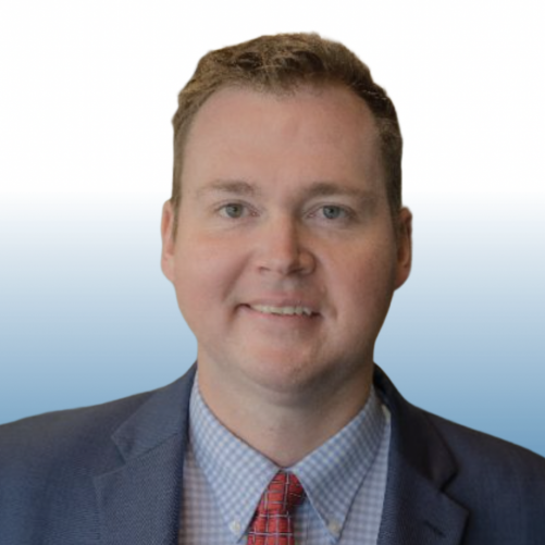 Man in a gray suit with a red tie, Equity team member headshot